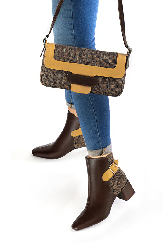 Dark brown and mustard yellow women's ankle boots with buckles at the back. Square toe. Medium block heels. Worn view - Florence KOOIJMAN